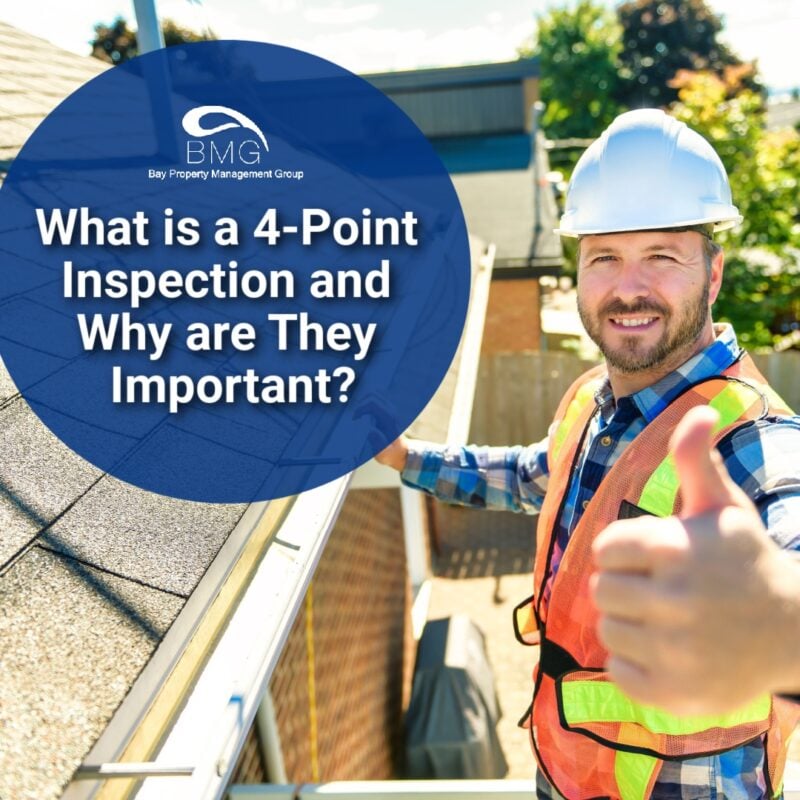 A construction worker wearing a hard hat and safety vest stands on a ladder next to a roof, giving a thumbs up. The text overlay reads: "What is a 4-Point Inspection and Why are They Important?" along with the logo for Bay Property Management Group.