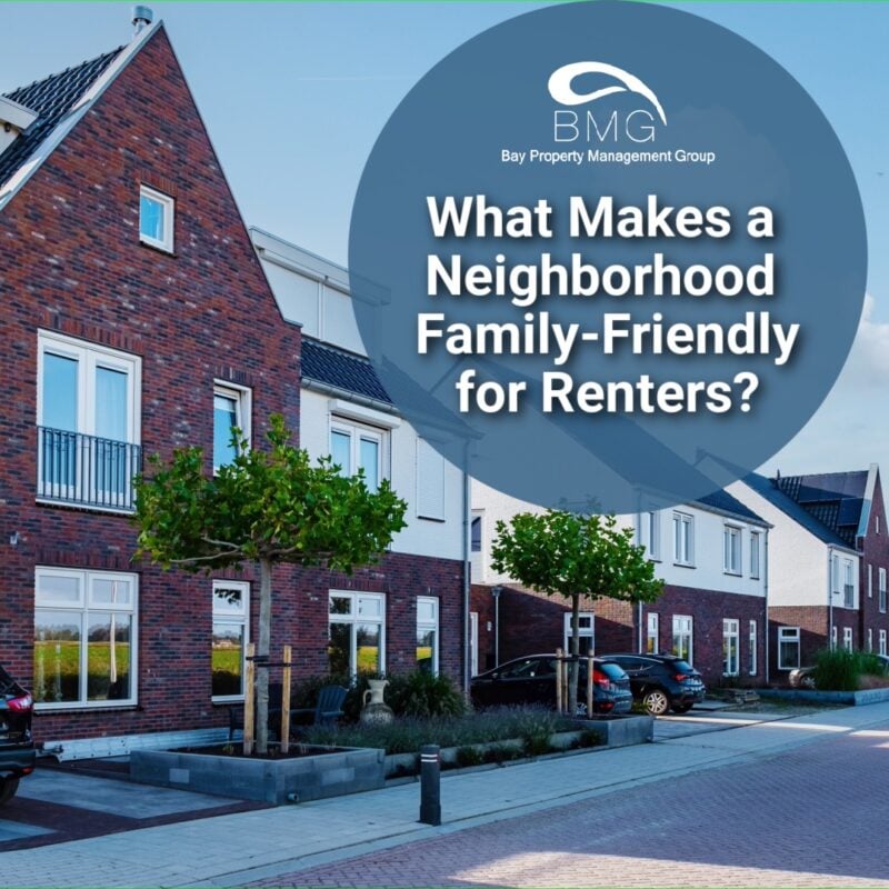 Modern suburban street with rows of red-brick houses, parked cars, and small trees along the sidewalk. In the foreground is a large circular overlay featuring the logo of Bay Property Management Group and the text "What Makes a Neighborhood Family-Friendly for Renters?"