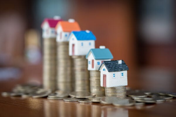 Mini house on stack of coins
