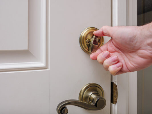 Locked apartment door with tenant trying the handle