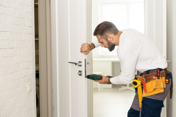 Licensed locksmith unlocking an apartment door after a tenant lockout