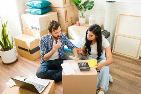 Tenants reviewing paperwork and move-in details while preparing to move into a new apartment.