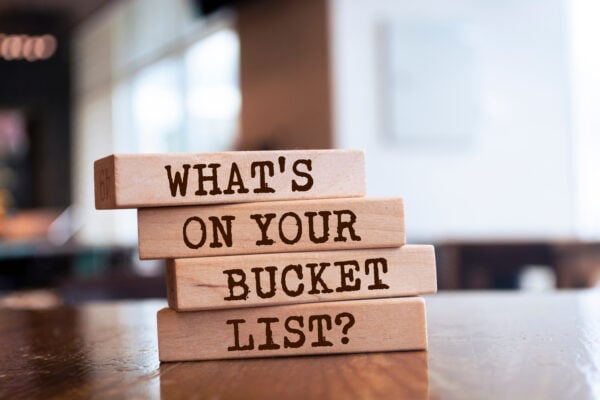 Wooden blocks with words 'What's On Your Bucket List?'. Business concept