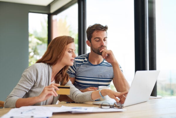 Tenants reviewing rent and lease documents while discussing payment concerns