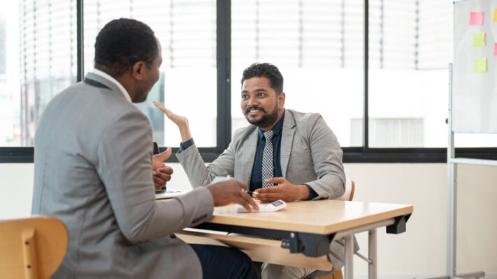 Landlord meeting with a property management professional about rental market strategy